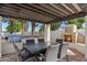 Outdoor kitchen with built-in BBQ, stone fireplace, dining table, and plenty of room to entertain at 11319 E Elmhurst Dr, Chandler, AZ 85249