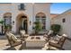 Inviting outdoor patio with a fire pit surrounded by comfortable seating, complemented by tasteful landscaping at 11319 E Elmhurst Dr, Chandler, AZ 85249