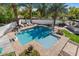Inviting backyard pool with basketball hoop, surrounded by lush landscaping and brick paving at 11319 E Elmhurst Dr, Chandler, AZ 85249
