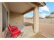 Covered back patio with red chairs offering a relaxing outdoor space at 11564 W Harrison St, Avondale, AZ 85323