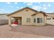 Spacious backyard with gravel landscaping, covered patio, and a cozy seating area, perfect for relaxing at 11564 W Harrison St, Avondale, AZ 85323