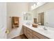 Well-lit bathroom with a double sink vanity and large mirror at 11564 W Harrison St, Avondale, AZ 85323
