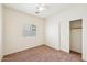 Carpeted bedroom with standard closet and window at 11564 W Harrison St, Avondale, AZ 85323