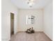 Bedroom with neutral carpet, ceiling fan, window, and a double sliding door closet at 11564 W Harrison St, Avondale, AZ 85323