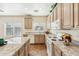 Bright, sunny kitchen with granite countertops, tile floor and ample storage space at 11564 W Harrison St, Avondale, AZ 85323