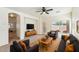 Spacious living room featuring plush seating, ceiling fan, neutral carpeting, and a bright window at 11564 W Harrison St, Avondale, AZ 85323