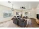 Cozy living room with neutral paint, large windows and comfortable seating at 11564 W Harrison St, Avondale, AZ 85323