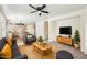 Inviting living room with stylish furniture, ceiling fan, and open-concept design at 11564 W Harrison St, Avondale, AZ 85323