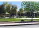 Community park features a playground, basketball court, grassy area and shaded seating areas at 11564 W Harrison St, Avondale, AZ 85323