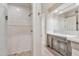 Bright bathroom features a glass shower with neutral tiles, updated vanity, and a large mirror at 12 E Oakwood Hills Dr, Chandler, AZ 85248