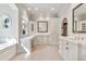 Luxurious bathroom with custom cabinets, marble countertops, dual sinks, and ample natural light at 12 E Oakwood Hills Dr, Chandler, AZ 85248