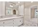 Spacious bathroom features a large mirror, dual access to additional living spaces, and modern fixtures at 12 E Oakwood Hills Dr, Chandler, AZ 85248
