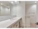 Bright bathroom featuring a large mirror, white marble countertops, and custom cabinets with stylish hardware at 12 E Oakwood Hills Dr, Chandler, AZ 85248