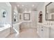 Luxurious bathroom with dual vanities, marble counters, and custom white cabinets at 12 E Oakwood Hills Dr, Chandler, AZ 85248