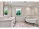Bright bathroom features a soaking tub, marble counters and floors, and a beautiful window view at 12 E Oakwood Hills Dr, Chandler, AZ 85248