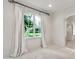 Bright bedroom with large window, transom, neutral paint, and white wooden flooring at 12 E Oakwood Hills Dr, Chandler, AZ 85248