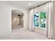 Bright bedroom with large window, transom, neutral paint, and carpet flooring at 12 E Oakwood Hills Dr, Chandler, AZ 85248