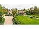 Elegant home showcasing meticulously maintained landscaping, mature trees, and a curved driveway at 12 E Oakwood Hills Dr, Chandler, AZ 85248
