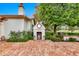 Cozy outdoor fireplace with brick base, perfect for evening gatherings, set against a backdrop of lush greenery and mature trees at 12 E Oakwood Hills Dr, Chandler, AZ 85248