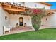 Inviting front entrance with a beautifully blooming bougainvillea, red brick, and elegant architectural details at 12 E Oakwood Hills Dr, Chandler, AZ 85248