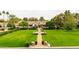 A stunning estate with mature trees, lush green lawns, a paver walkway, and manicured landscaping at 12 E Oakwood Hills Dr, Chandler, AZ 85248