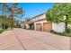Spacious three-car garage with wooden doors and meticulously maintained landscaping creates an inviting exterior at 12 E Oakwood Hills Dr, Chandler, AZ 85248