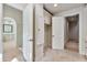 Hallway with tile flooring, built-in storage, and doorways leading to other rooms in the home at 12 E Oakwood Hills Dr, Chandler, AZ 85248