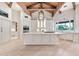 Bright, white kitchen with a large island, stainless steel appliances, custom cabinets, and hardwood floors at 12 E Oakwood Hills Dr, Chandler, AZ 85248
