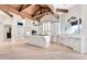 Open kitchen features a large island, breakfast bar, custom white cabinets, and stainless steel appliances at 12 E Oakwood Hills Dr, Chandler, AZ 85248