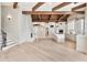 This open-concept kitchen features a large island, white cabinets, stainless appliances, and wood beam ceiling at 12 E Oakwood Hills Dr, Chandler, AZ 85248
