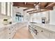 Bright kitchen features custom cabinets, marble counters, island with cooktop, and stainless steel appliances at 12 E Oakwood Hills Dr, Chandler, AZ 85248