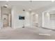 Spacious living room with neutral paint, carpet flooring, and built in shelving at 12 E Oakwood Hills Dr, Chandler, AZ 85248
