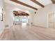 Bright, open living area featuring hardwood floors, exposed beams, and seamless transition to the kitchen at 12 E Oakwood Hills Dr, Chandler, AZ 85248
