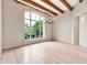 Elegant living room with hardwood floors, exposed beams, and a large window for natural light at 12 E Oakwood Hills Dr, Chandler, AZ 85248