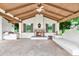 Spacious outdoor living area with stone floors, fireplace, and beamed ceiling, perfect for entertaining at 12 E Oakwood Hills Dr, Chandler, AZ 85248