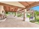 Spacious covered patio featuring a stone fireplace, built-in bench, and wood beam ceiling, perfect for outdoor entertaining at 12 E Oakwood Hills Dr, Chandler, AZ 85248