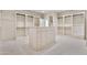 Expansive walk-in closet featuring custom shelving, drawers, and a central island for storage and organization at 12 E Oakwood Hills Dr, Chandler, AZ 85248