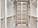 Spacious walk-in closet with custom shelving, closet rods, and carpet flooring at 12 E Oakwood Hills Dr, Chandler, AZ 85248