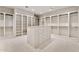Spacious walk-in closet with custom shelving, center island and drawers at 12 E Oakwood Hills Dr, Chandler, AZ 85248