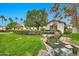 Picturesque water feature in lush community landscaping; a tranquil scene with mature trees and manicured hedges at 12 E Oakwood Hills Dr, Chandler, AZ 85248