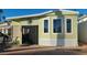 Inviting mobile home with a charming exterior, featuring a cozy porch area at 1284 S Sioux Dr # 1284, Apache Junction, AZ 85119