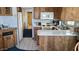 Efficient kitchen layout with appliances and view into bathroom at 1284 S Sioux Dr # 1284, Apache Junction, AZ 85119