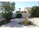 Landscaped backyard featuring a fountain, trees, shrubs, and a glimpse of the home at 1417 W Lake Mirage Ct, Gilbert, AZ 85233