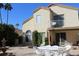 Spacious backyard with patio furniture, a fountain, lush greenery, and a two-story home at 1417 W Lake Mirage Ct, Gilbert, AZ 85233