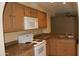 A cozy kitchen with cabinets, granite countertops, white appliances, and a double basin sink at 1417 W Lake Mirage Ct, Gilbert, AZ 85233