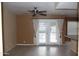 Bright living room with tile flooring and a door leading to the backyard at 1417 W Lake Mirage Ct, Gilbert, AZ 85233