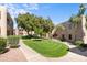 Exterior shot of manicured lawn in community with mature trees and surrounding multi-story buildings at 14645 N Fountain Hills N Blvd # 215, Fountain Hills, AZ 85268
