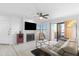 Bright living room featuring a tile fireplace, ceiling fan, sliding glass doors to balcony, and comfortable seating at 14645 N Fountain Hills N Blvd # 215, Fountain Hills, AZ 85268