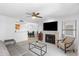 Open concept living room with tile fireplace, ceiling fan, and view to the kitchen and dining room at 14645 N Fountain Hills N Blvd # 215, Fountain Hills, AZ 85268