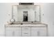Elegant bathroom featuring double sinks with granite countertops and a large mirror at 16573 W Alameda Rd, Surprise, AZ 85387